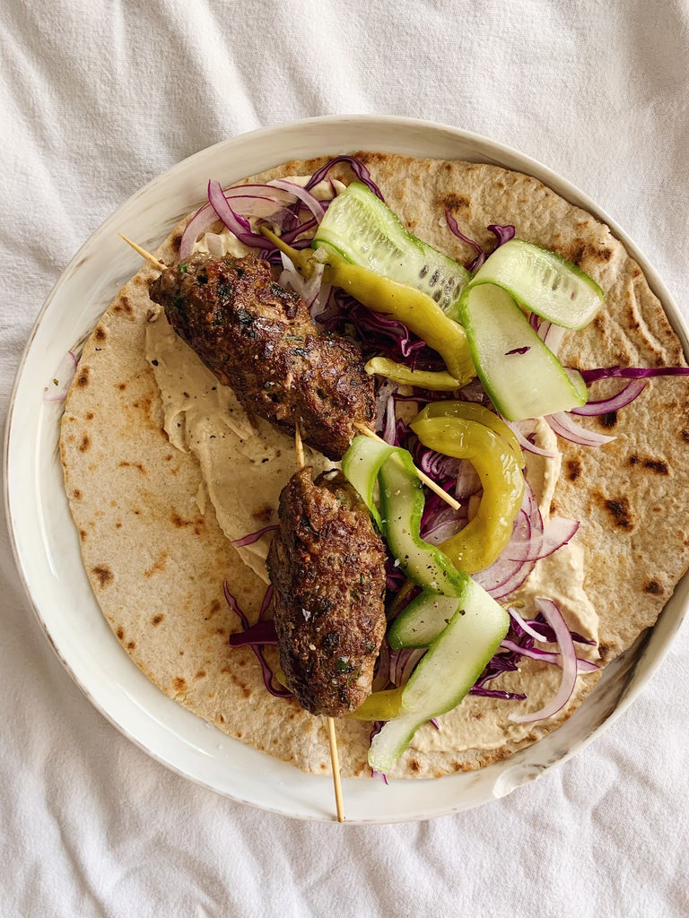 Beef kebabs with hummus and cabbage slaw