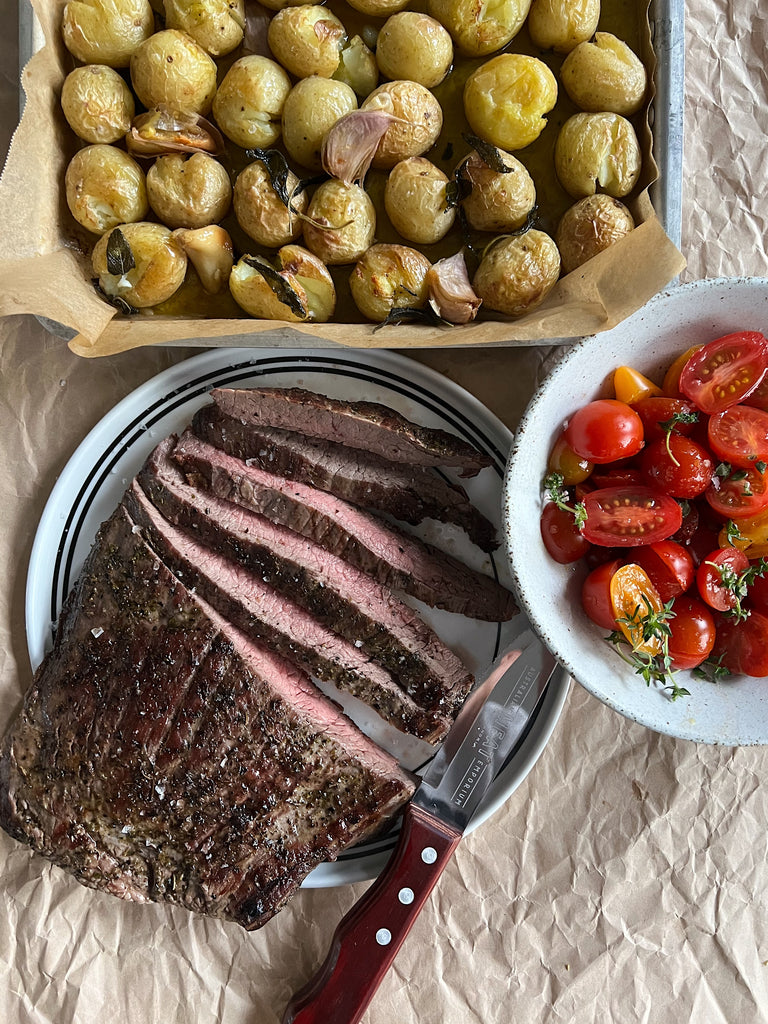 Flank steak with smoked butter potatoes and tomato salad