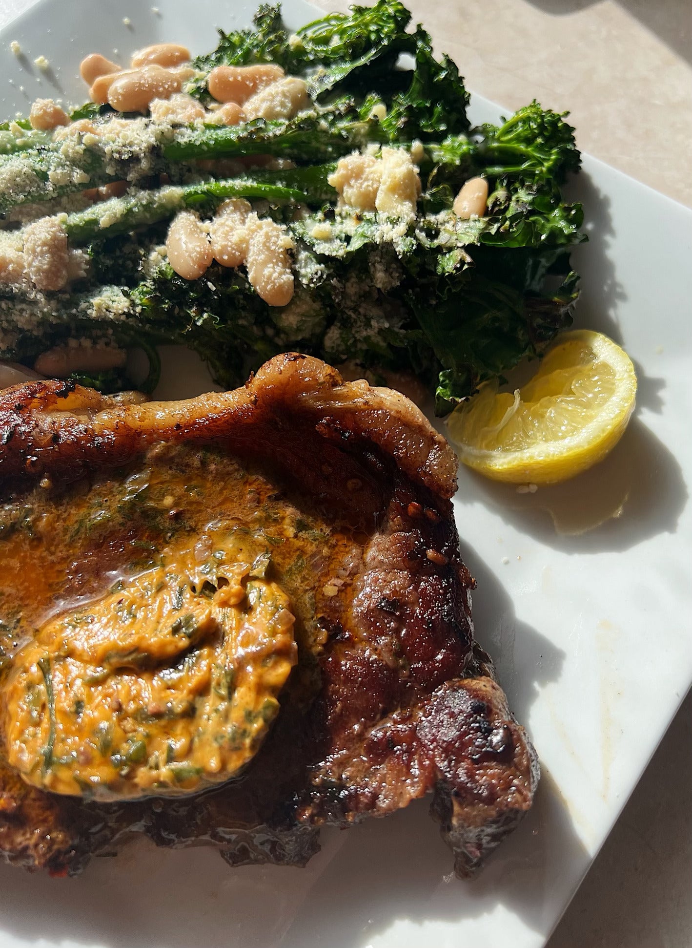 Porterhouse steak with charred greens and bean salad