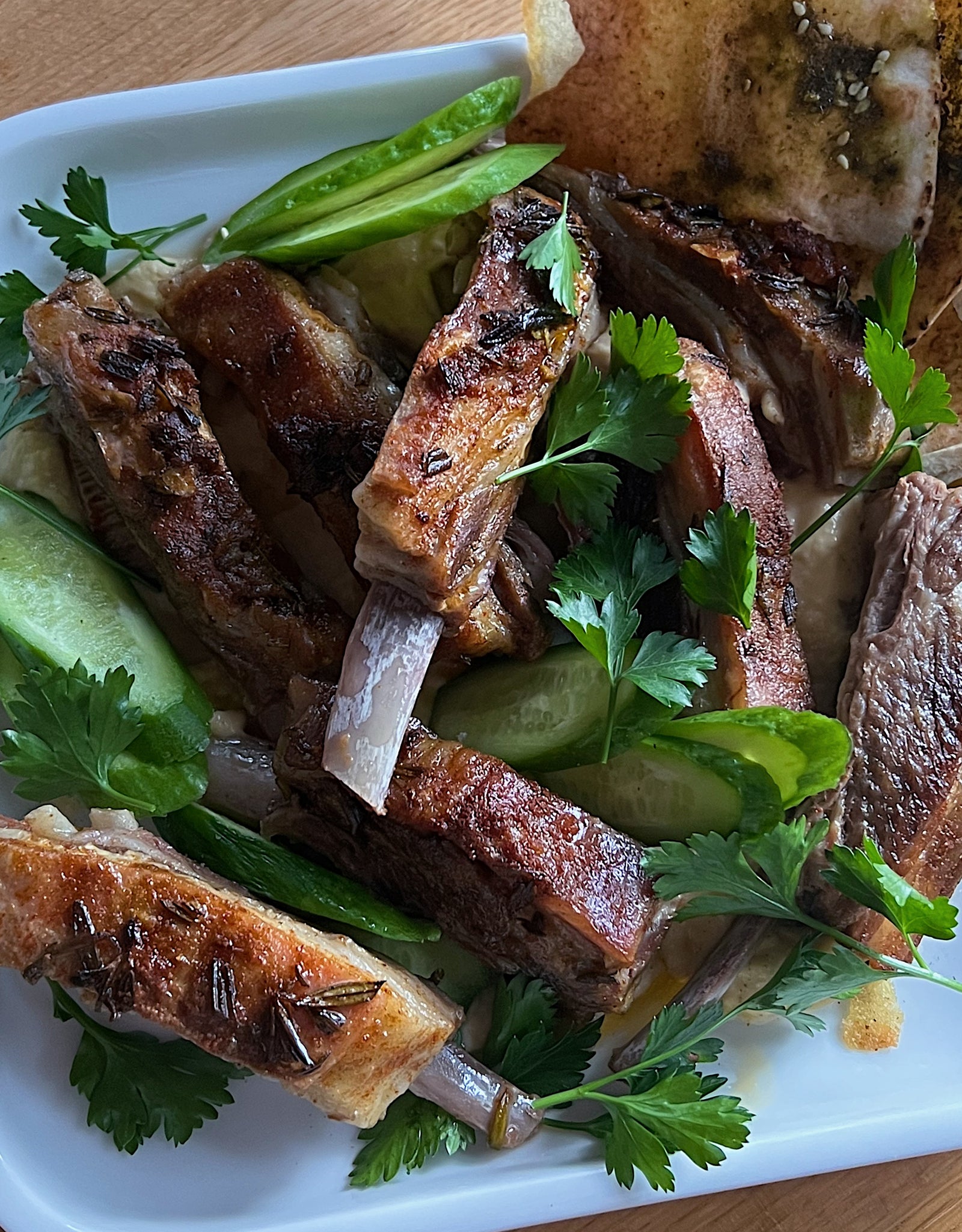 Lamb riblets with hummus and pita
