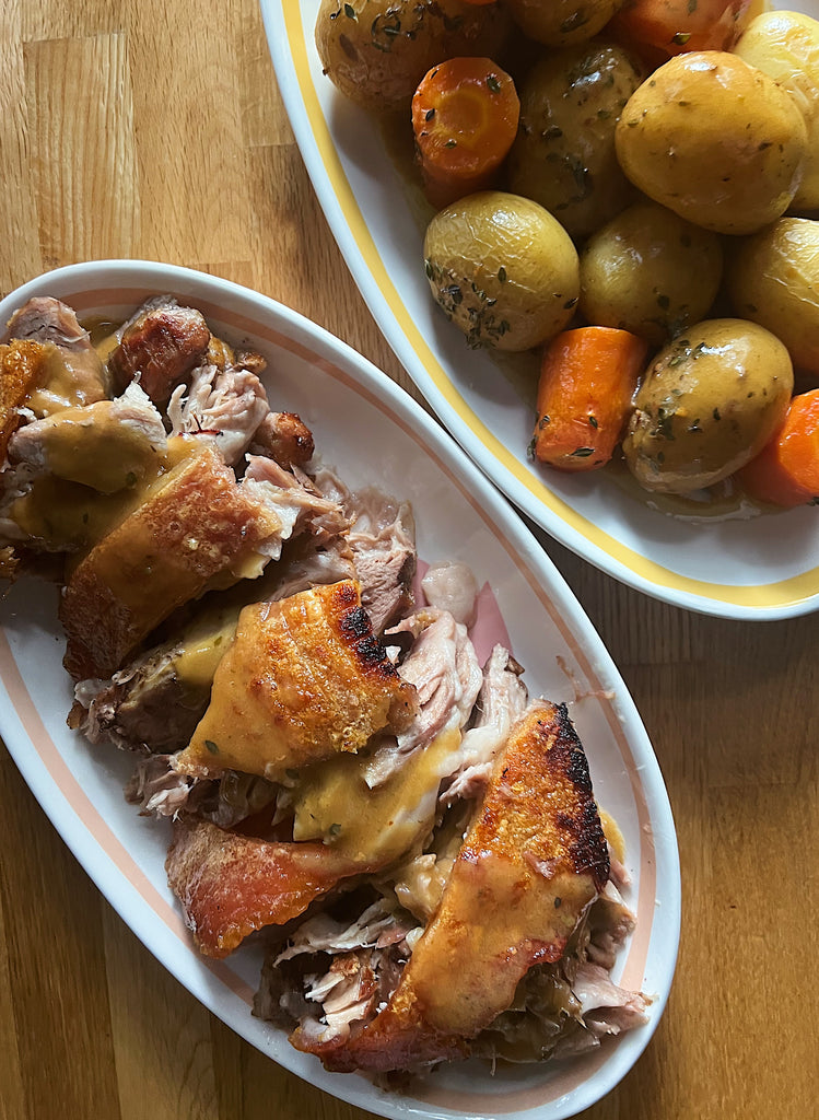 Sunday roast pork shoulder with roasted vegetables and gravy