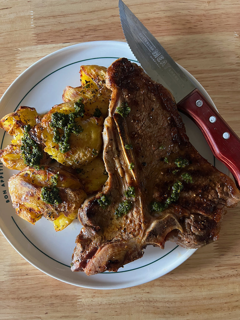 T-bone steak, crispy roasted potatoes and chimichurri